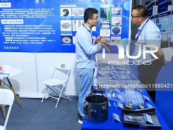 Visitors communicate with exhibitors at the 9th China Advanced Materials Industry Expo 2024 in Qingdao, China, on October 12, 2024. (