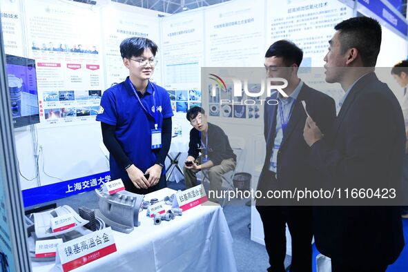 Visitors look at new materials and products at the 9th China Advanced Materials Industry Expo 2024 in Qingdao, China, on October 12, 2024. 