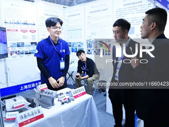 Visitors look at new materials and products at the 9th China Advanced Materials Industry Expo 2024 in Qingdao, China, on October 12, 2024. (