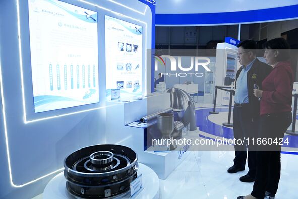 Visitors look at new materials and products at the 9th China Advanced Materials Industry Expo 2024 in Qingdao, China, on October 12, 2024. 