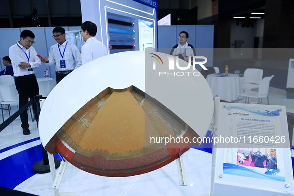 Visitors look at new materials and products at the 9th China Advanced Materials Industry Expo 2024 in Qingdao, China, on October 12, 2024. 