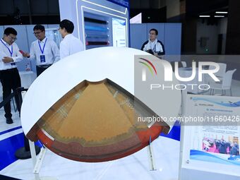 Visitors look at new materials and products at the 9th China Advanced Materials Industry Expo 2024 in Qingdao, China, on October 12, 2024. (