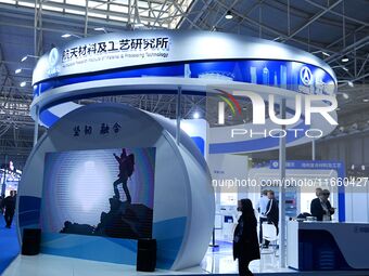 Visitors visit the booth of the Aerospace Materials and Technology Research Institute at the 9th China Advanced Materials Industry Expo 2024...