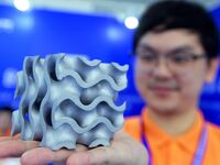 An exhibitor displays a 3D printed aluminum alloy lattice structure at the 9th China Advanced Materials Industry Expo 2024 in Qingdao, China...