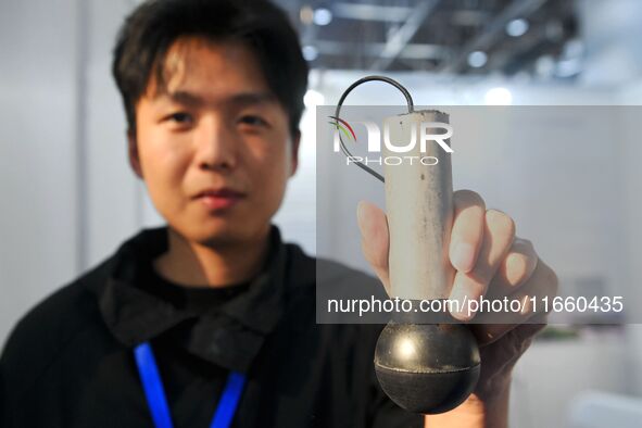 An exhibitor displays a high-precision sensor at the 9th China Advanced Materials Industry Expo 2024 in Qingdao, China, on October 12, 2024....