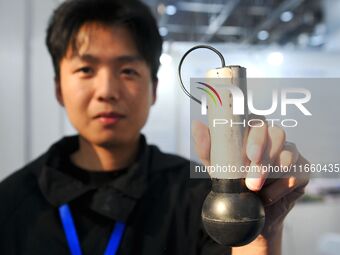 An exhibitor displays a high-precision sensor at the 9th China Advanced Materials Industry Expo 2024 in Qingdao, China, on October 12, 2024....