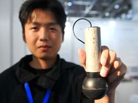 An exhibitor displays a high-precision sensor at the 9th China Advanced Materials Industry Expo 2024 in Qingdao, China, on October 12, 2024....