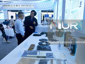 Visitors look at new materials and products at the 9th China Advanced Materials Industry Expo 2024 in Qingdao, China, on October 12, 2024. (