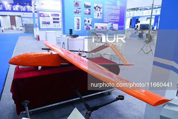 An exhibitor shows a target machine at the 9th China Advanced Materials Industry Expo 2024 in Qingdao, China, on October 12, 2024. 