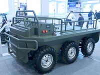 An exhibitor shows a guarantee following an unmanned vehicle at the 9th China Advanced Materials Industry Expo 2024 in Qingdao, China, on Oc...