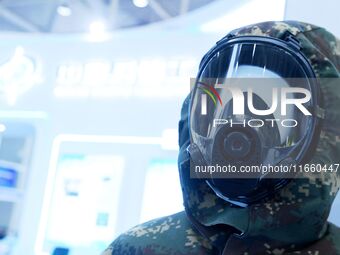 An exhibitor displays personal wear and protective equipment at the 9th China Advanced Materials Industry Expo 2024 in Qingdao, China, on Oc...