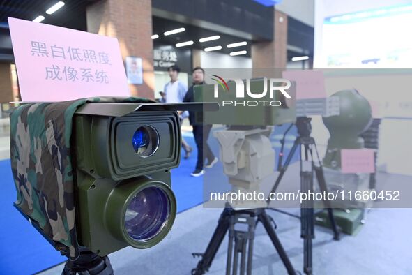 An exhibitor displays a black and white low-light imaging system at the 9th China Advanced Materials Industry Expo 2024 in Qingdao, China, o...