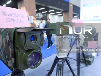 An exhibitor displays a black and white low-light imaging system at the 9th China Advanced Materials Industry Expo 2024 in Qingdao, China, o...