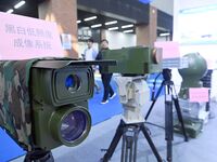 An exhibitor displays a black and white low-light imaging system at the 9th China Advanced Materials Industry Expo 2024 in Qingdao, China, o...