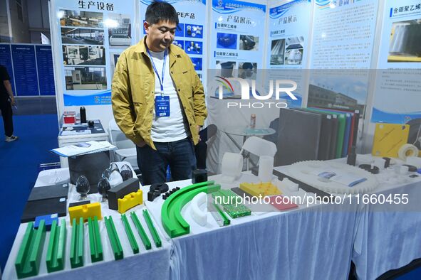 An exhibitor displays new nuclear energy materials at the 9th China Advanced Materials Industry Expo 2024 in Qingdao, China, on October 12,...