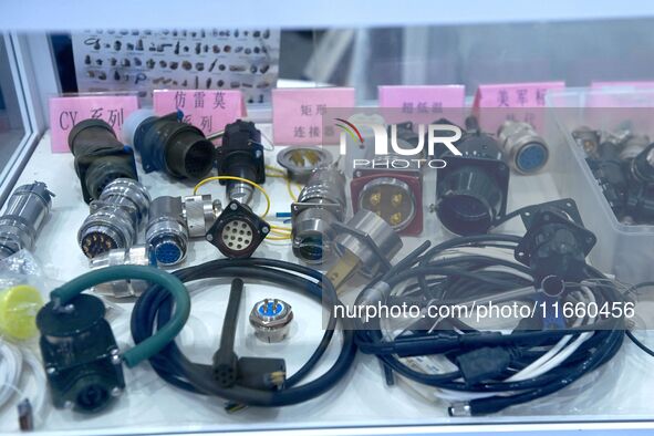 An exhibitor shows a dual-use connector at the 9th China Advanced Materials Industry Expo 2024 in Qingdao, China, on October 12, 2024. 