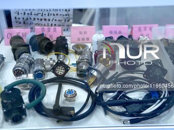 An exhibitor shows a dual-use connector at the 9th China Advanced Materials Industry Expo 2024 in Qingdao, China, on October 12, 2024. (