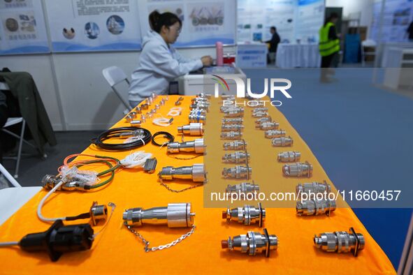 An exhibitor shows a dual-use connector at the 9th China Advanced Materials Industry Expo 2024 in Qingdao, China, on October 12, 2024. 