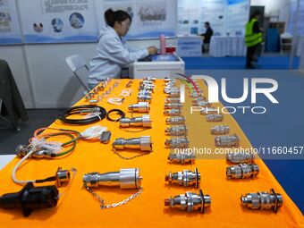 An exhibitor shows a dual-use connector at the 9th China Advanced Materials Industry Expo 2024 in Qingdao, China, on October 12, 2024. (