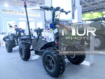 An exhibitor displays an all-terrain powered skateboard carrier at the 9th China Advanced Materials Industry Expo 2024 in Qingdao, China, on...