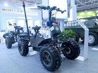 An exhibitor displays an all-terrain powered skateboard carrier at the 9th China Advanced Materials Industry Expo 2024 in Qingdao, China, on...