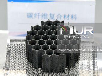 An exhibitor displays carbon fiber compliance materials at the 9th China Advanced Materials Industry Expo 2024 in Qingdao, China, on October...