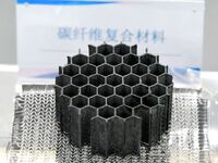 An exhibitor displays carbon fiber compliance materials at the 9th China Advanced Materials Industry Expo 2024 in Qingdao, China, on October...