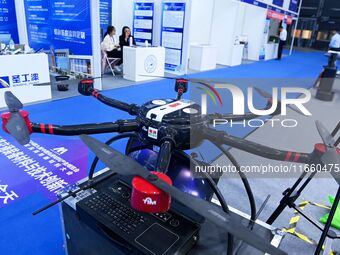 An exhibitor shows a drone at the 9th China Advanced Materials Industry Expo 2024 in Qingdao, China, on October 12, 2024. (