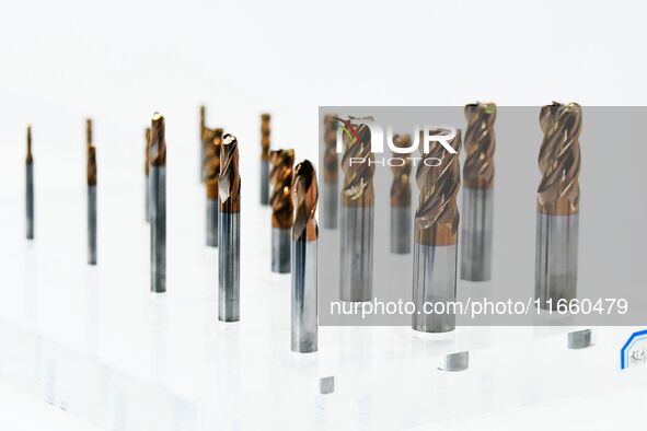 An exhibitor displays a new material composite drill bit at the 9th China Advanced Materials Industry Expo 2024 in Qingdao, China, on Octobe...