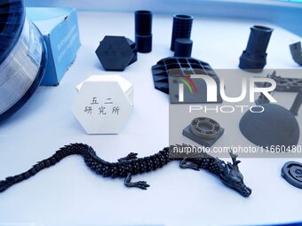 An exhibitor displays new ceramic materials and products at the 9th China Advanced Materials Industry Expo 2024 in Qingdao, China, on Octobe...