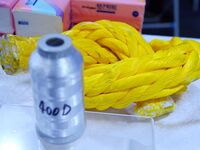 An exhibitor displays new fiber materials and products at the 9th China Advanced Materials Industry Expo 2024 in Qingdao, China, on October...