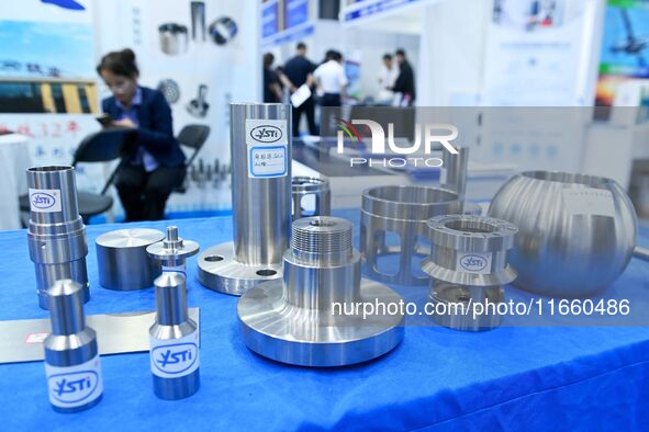 An exhibitor displays titanium alloy materials and products at the 9th China Advanced Materials Industry Expo 2024 in Qingdao, China, on Oct...