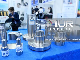 An exhibitor displays titanium alloy materials and products at the 9th China Advanced Materials Industry Expo 2024 in Qingdao, China, on Oct...