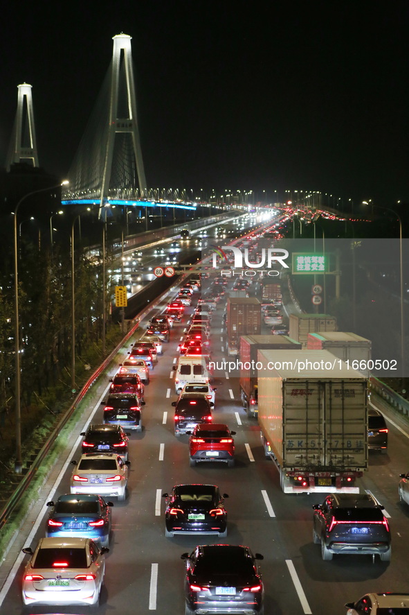 Weekend rush hour traffic occurs on the outer ring highway of Xupu Bridge in Shanghai, China, on October 12, 2024. 