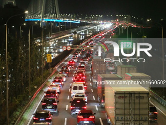 Weekend rush hour traffic occurs on the outer ring highway of Xupu Bridge in Shanghai, China, on October 12, 2024. (