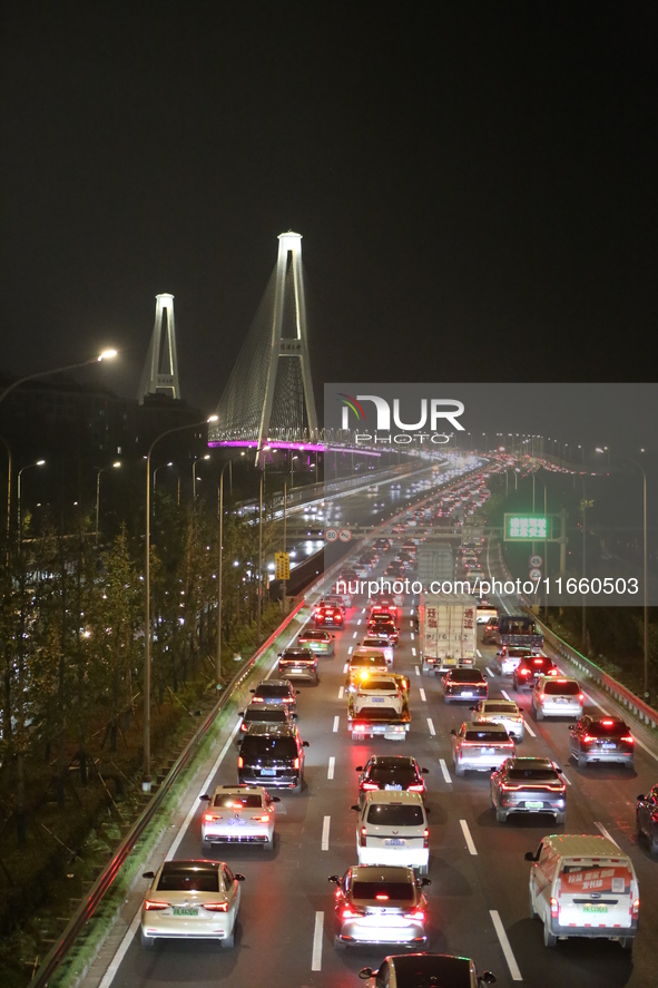 Weekend rush hour traffic occurs on the outer ring highway of Xupu Bridge in Shanghai, China, on October 12, 2024. 