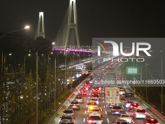 Weekend rush hour traffic occurs on the outer ring highway of Xupu Bridge in Shanghai, China, on October 12, 2024. (