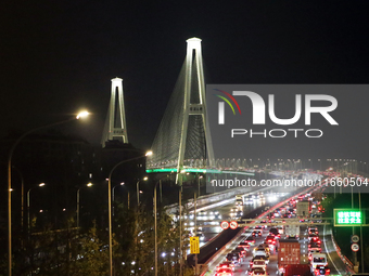 Weekend rush hour traffic occurs on the outer ring highway of Xupu Bridge in Shanghai, China, on October 12, 2024. (