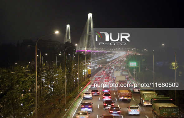 Weekend rush hour traffic occurs on the outer ring highway of Xupu Bridge in Shanghai, China, on October 12, 2024. 