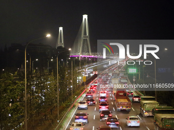 Weekend rush hour traffic occurs on the outer ring highway of Xupu Bridge in Shanghai, China, on October 12, 2024. (