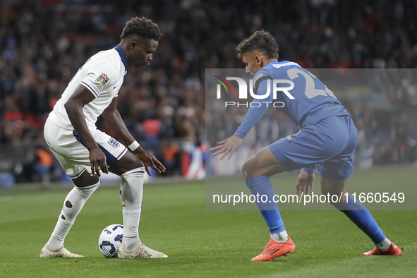 Bukayo Saka of England and Dimitris Giannoulis of Greece are in action during the football game between England and Greece for the UEFA Nati...