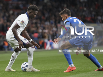 Bukayo Saka of England and Dimitris Giannoulis of Greece are in action during the football game between England and Greece for the UEFA Nati...