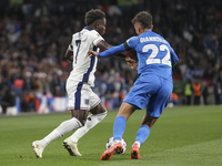 Bukayo Saka of England and Dimitris Giannoulis of Greece are in action during the football game between England and Greece for the UEFA Nati...