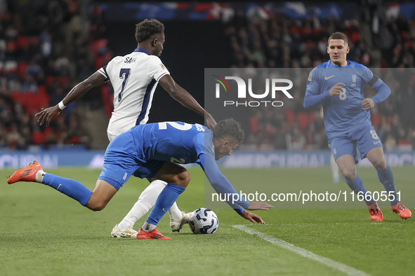 Bukayo Saka of England and Dimitris Giannoulis of Greece are in action during the football game between England and Greece for the UEFA Nati...