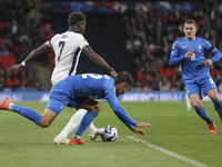 Bukayo Saka of England and Dimitris Giannoulis of Greece are in action during the football game between England and Greece for the UEFA Nati...