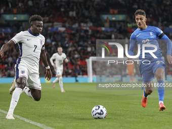 Bukayo Saka of England and Dimitris Giannoulis of Greece are in action during the football game between England and Greece for the UEFA Nati...