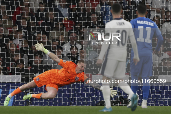 Vangelis Pavlidis of Greece scores a goal while Goalkeeper Jordan Pickford of England tries to save during the football game between England...