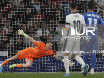 Vangelis Pavlidis of Greece scores a goal while Goalkeeper Jordan Pickford of England tries to save during the football game between England...