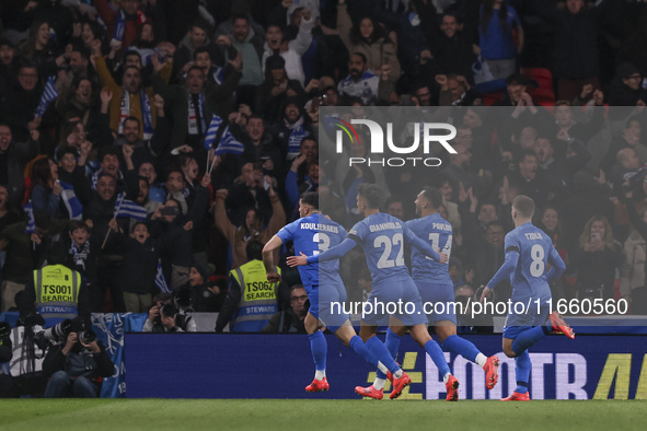 Konstantinos Koulierakis, Dimitris Giannoulis, Vangelis Pavlidis, and Christos Tzolis of Greece celebrate Greece's goal in front of the Gree...