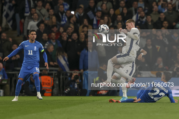 Cole Palmer of England is in the air and Dimitris Giannoulis of Greece is in action during the football game between England and Greece for...